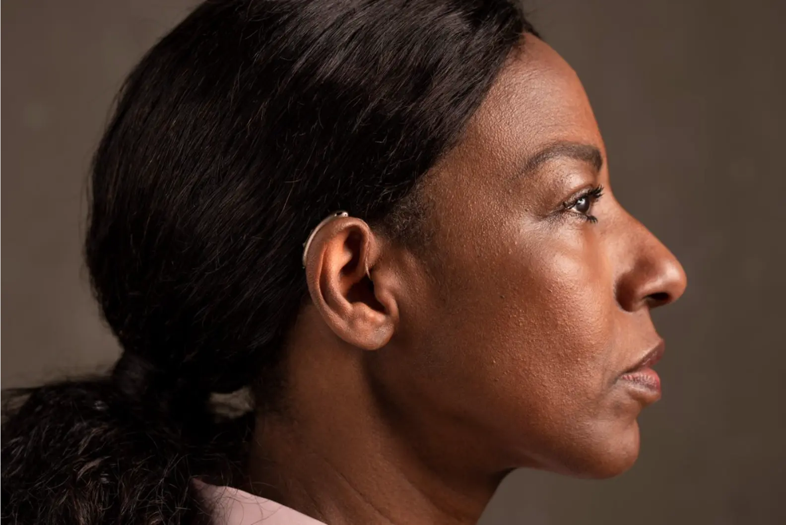 Mulher tratando perda auditiva e ouvindo bem com aparelho Amplifittá em Canoas